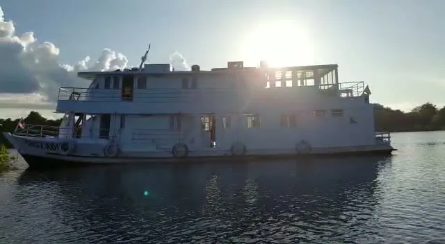 A boat crossing wide open water on the Amazon