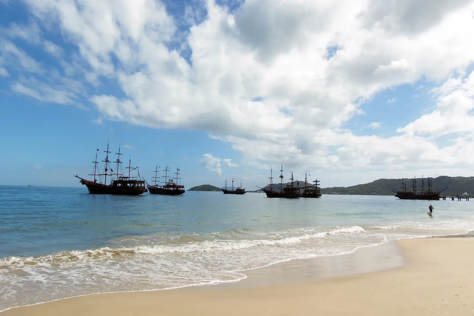 Traditional wooden tourist schooners anchored off the beach at Canasvieiras, where the Anhatomirim trips set out from