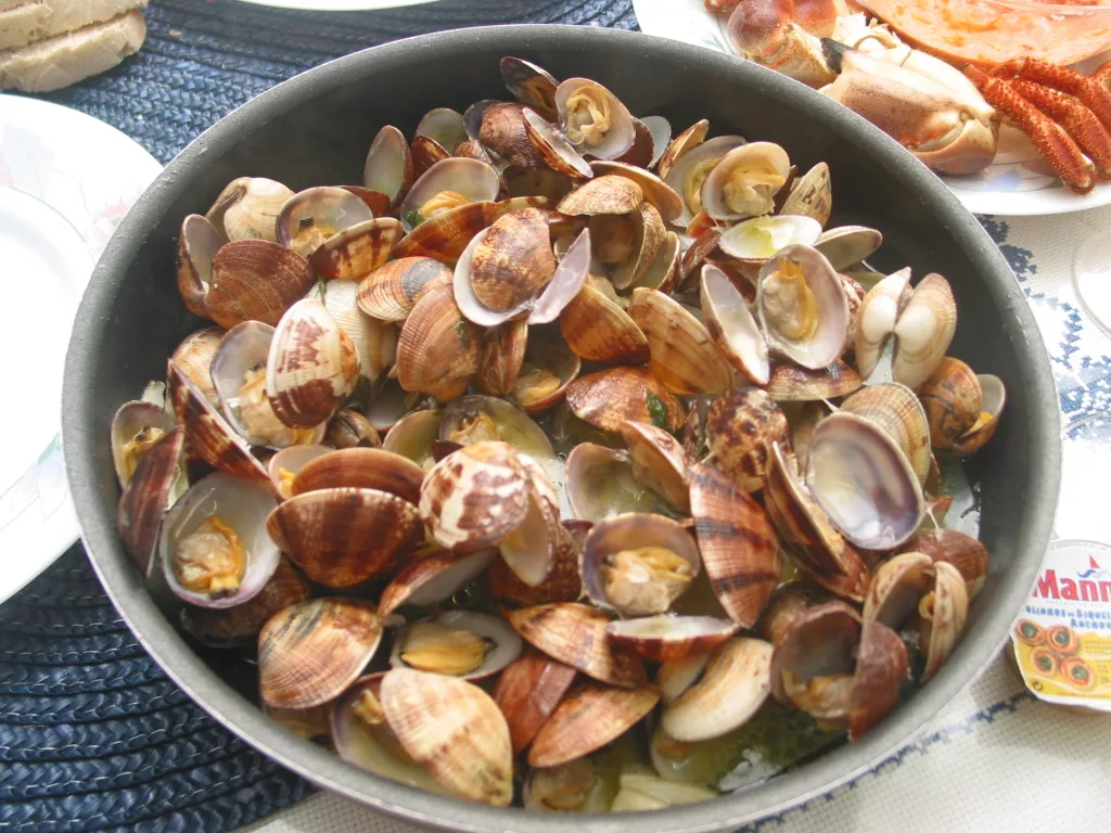 A dish of small cockles steamed in garlic, olive oil and parsley
