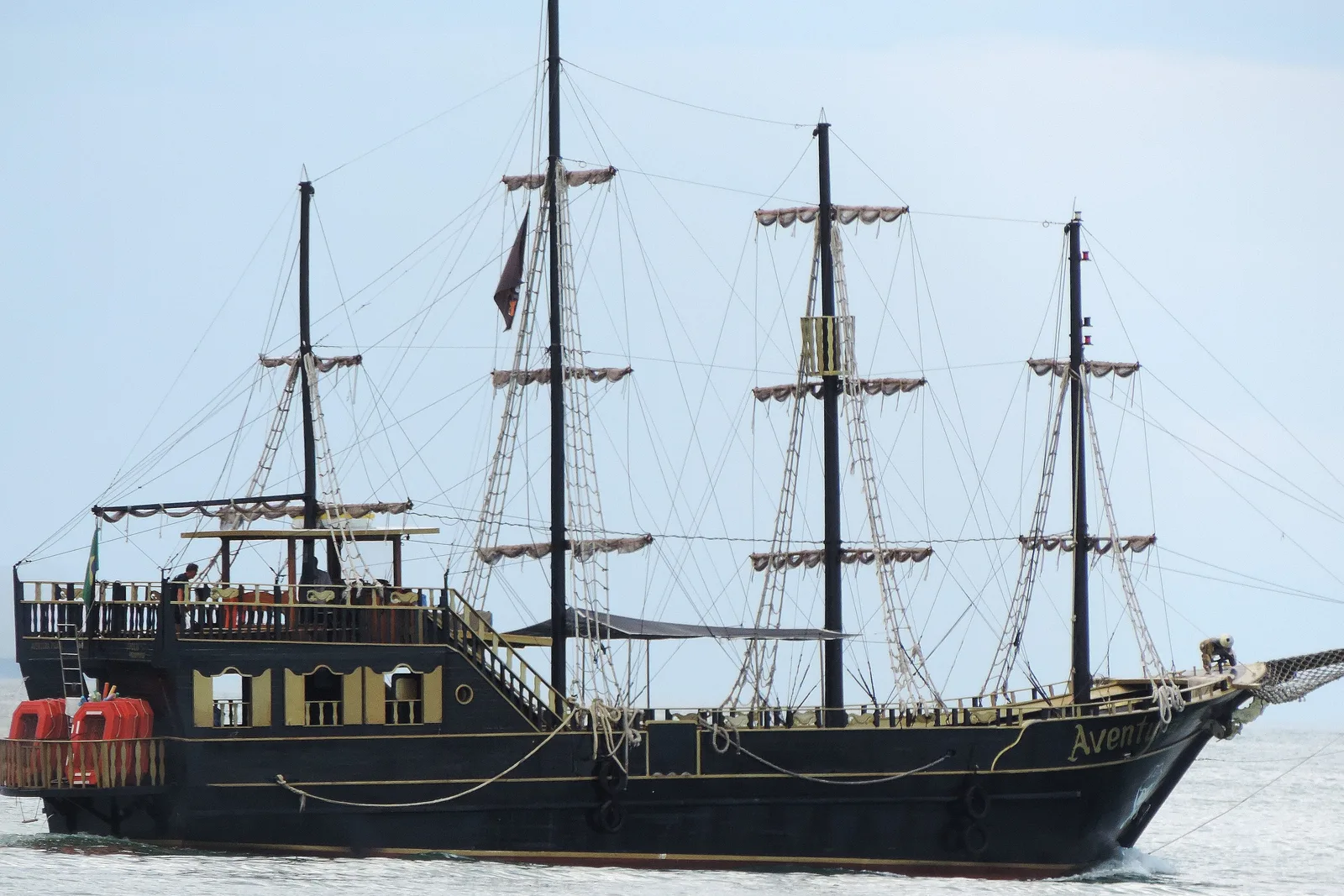 A traditional wooden tour schooner on the calm bay off Florianópolis