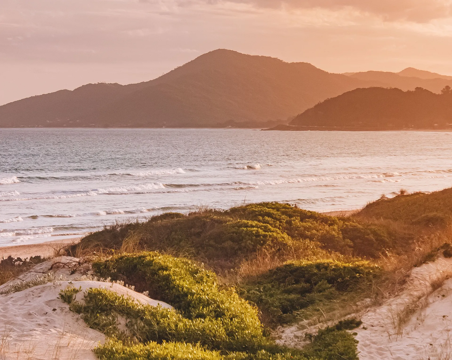 Surf and sand dunes at Joaquina beach, Florianópolis