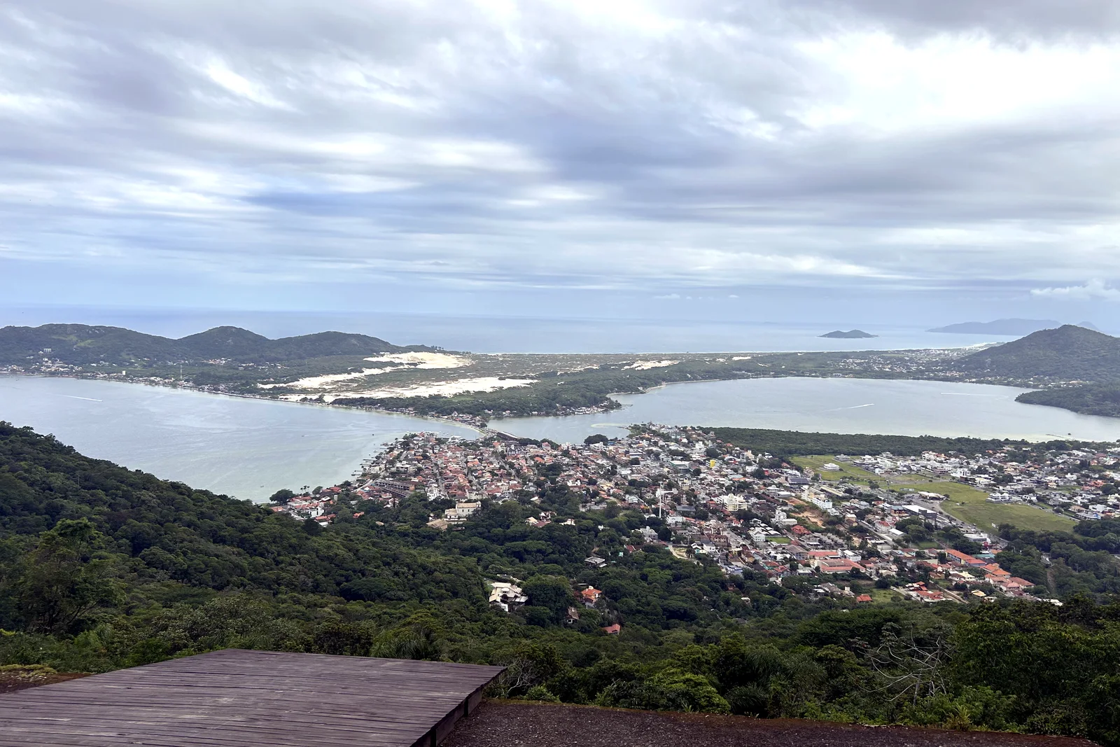 The view from the Morro da Lagoa lookout over Lagoa da Conceição: the town on the isthmus, the lagoon on both sides, the dune field and the ocean beyond