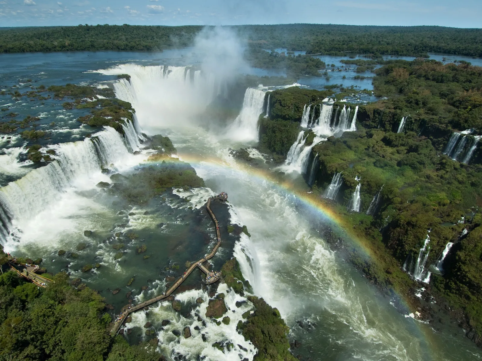 A full rainbow standing in the spray over Iguaçu Falls