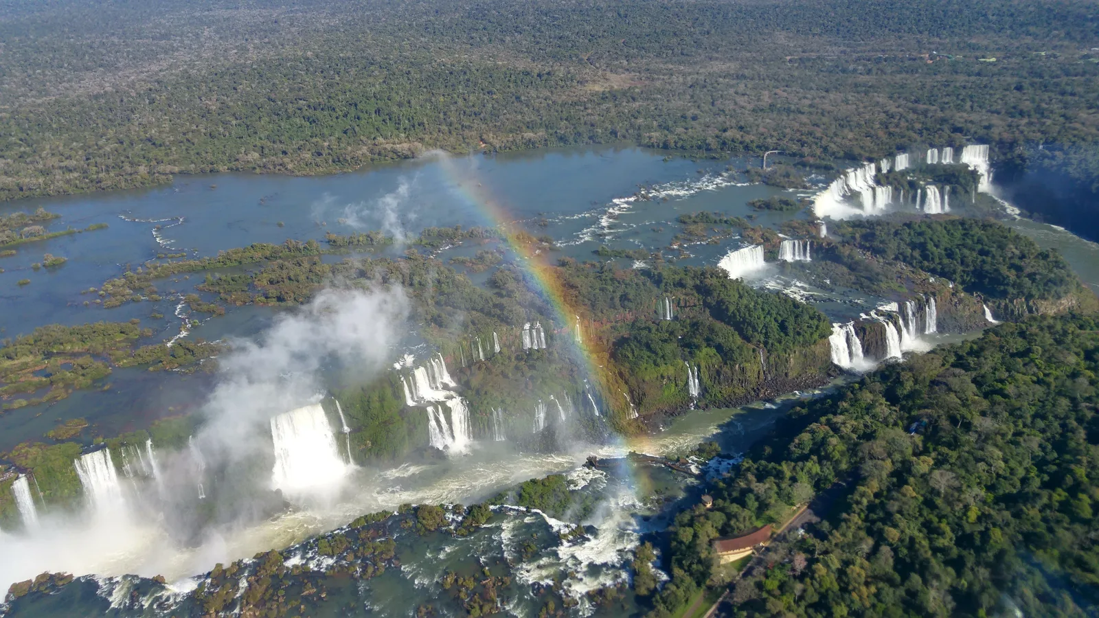 Iguaçu Falls from the air, a rainbow standing over the spray