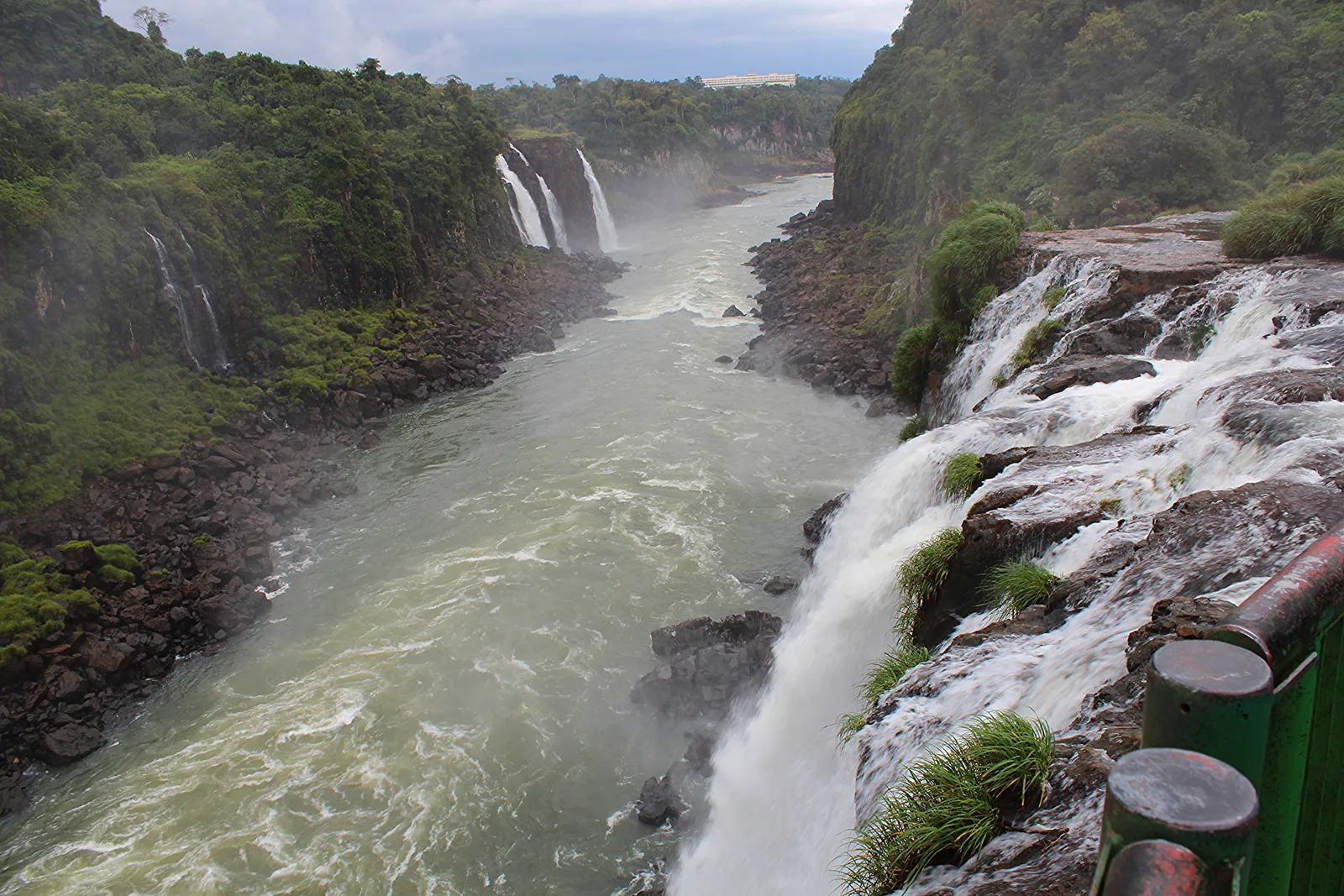 The Iguaçu river below the falls, narrowing into its canyon between shelves of basalt with rapids running down the middle