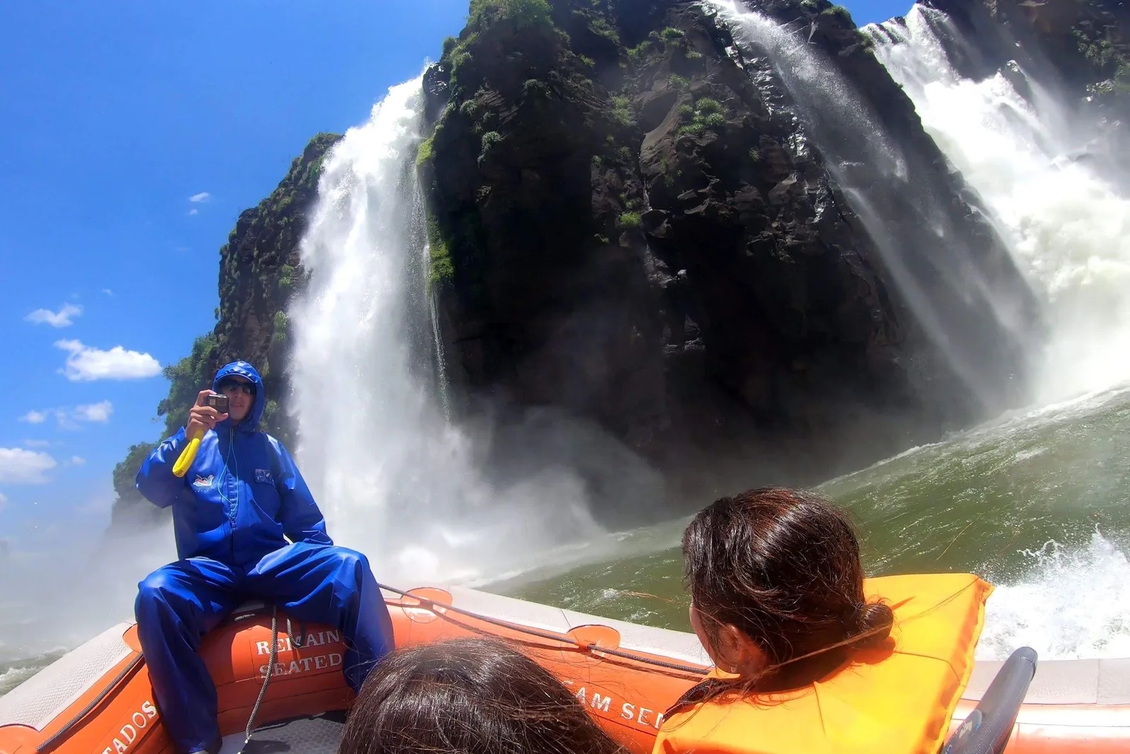 A boat taking passengers under the falls at Iguaçu