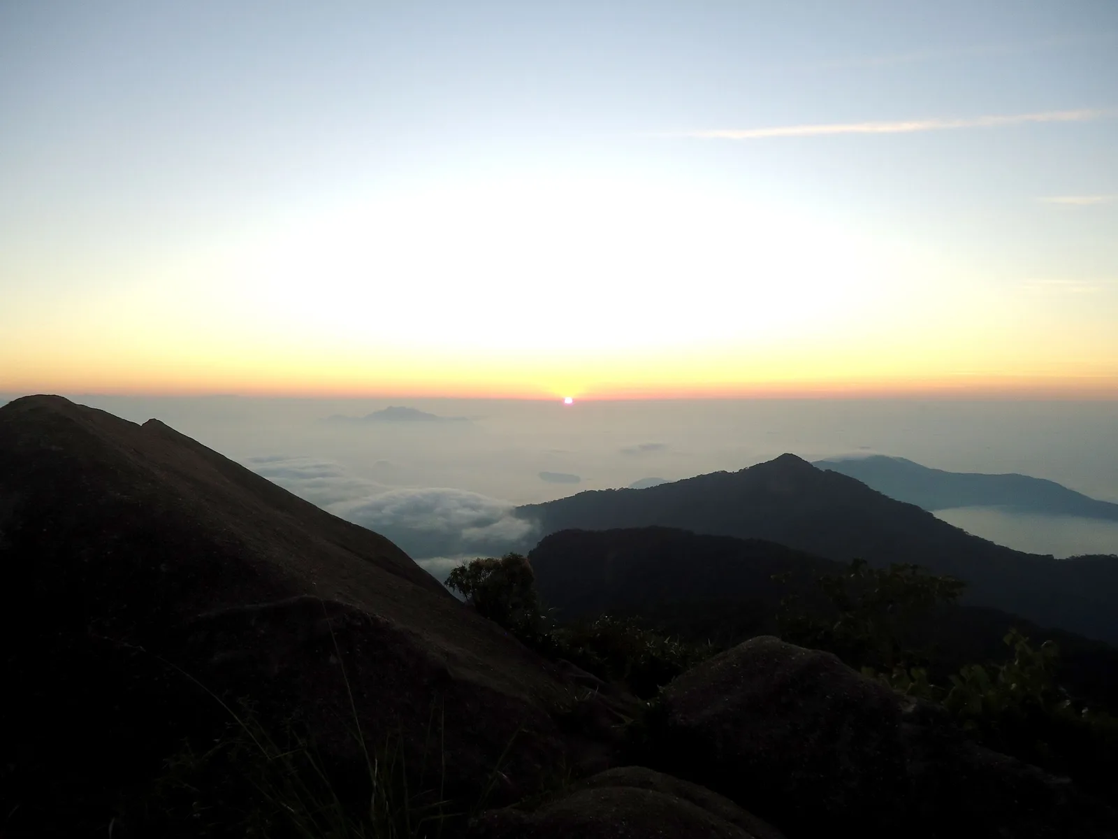 Sunrise from the summit of Pico do Papagaio, the island’s forested ridges falling away below into low cloud