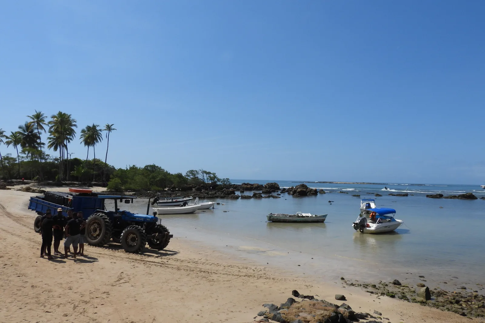 A tractor parked on the sand beside moored speedboats at Morro de São Paulo, the island’s substitute for a road vehicle
