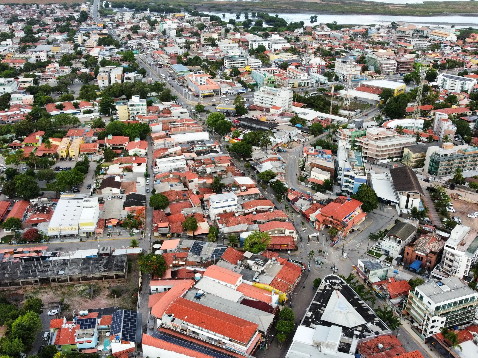 Aerial view over the center of Porto de Galinhas: a dense grid of red-tiled roofs and low buildings packed together with streets running through them