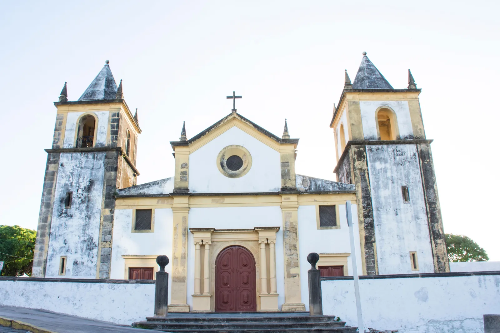 The weathered twin-towered facade of Olinda’s cathedral, the Igreja da Sé, seen from the square in front of it
