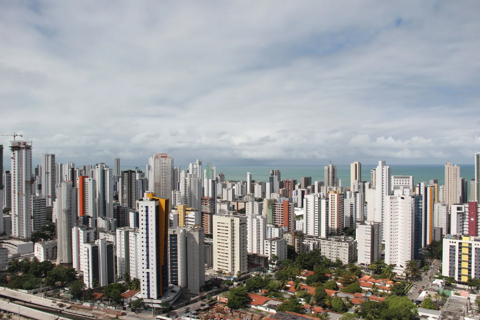 Boa Viagem from the air: block after block of apartment towers packed in tight behind the seafront avenue, running away toward the horizon