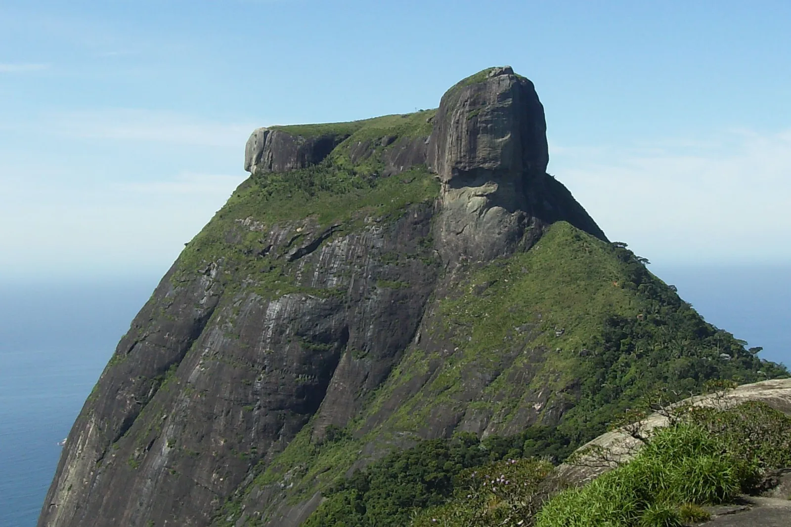 The flat-topped monolith of Pedra da Gávea rising out of dense forest, its bare rock face catching the light