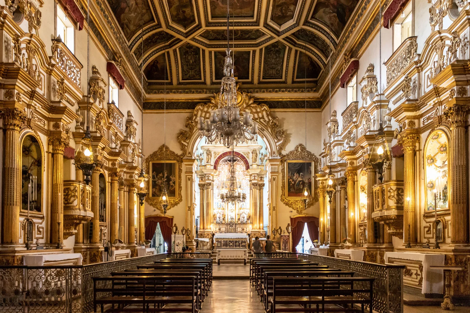 The gilded nave of the Igreja da Ordem Terceira de São Francisco, carved gold on every wall and chandeliers down the middle