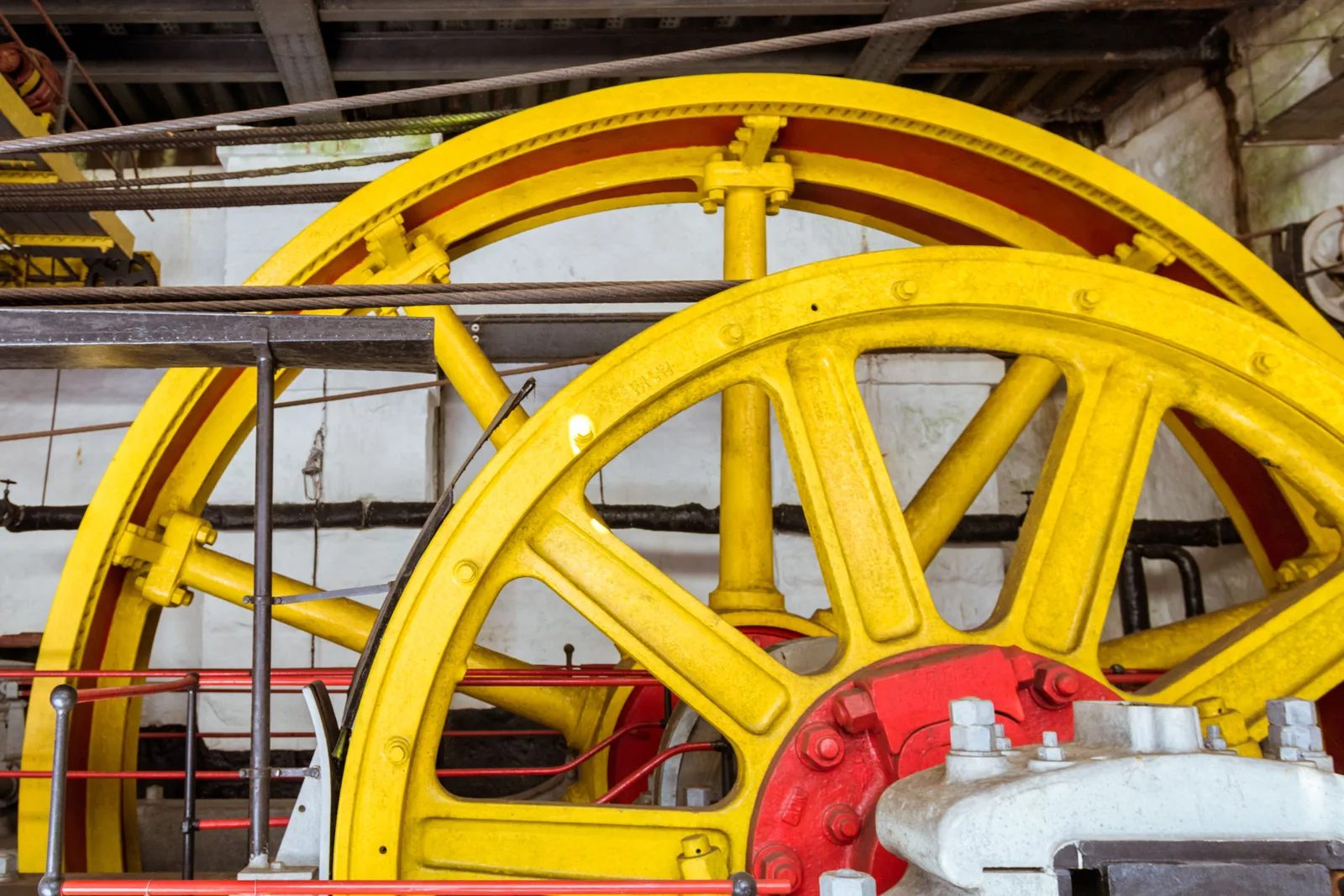 The huge yellow cable drum of the old funicular winding engine at Paranapiacaba, its red hub and spokes filling an iron-framed engine house